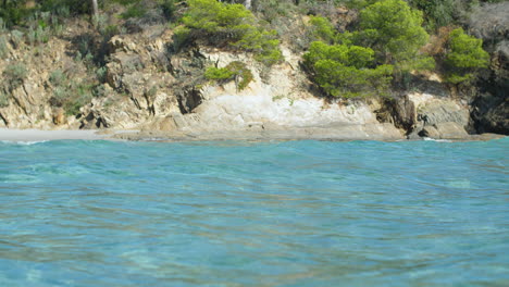 Mediterranean-coastline-blue-sea-waves-and-rocky-and-green-cliffs